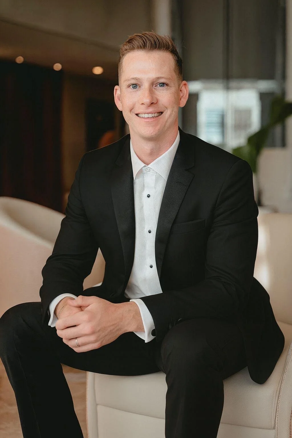 Jacob Jenkins, CEO and founder of MOLAR AI, seated in a black suit and smiling